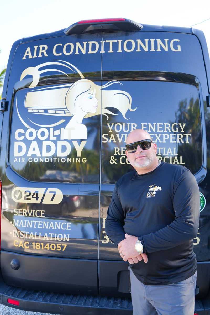 Alex Castillo, owner of Cool It Daddy Air Conditioning, standing in front of his company van